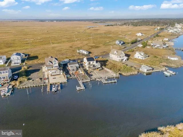 a living room with furniture a flat screen tv and a large window