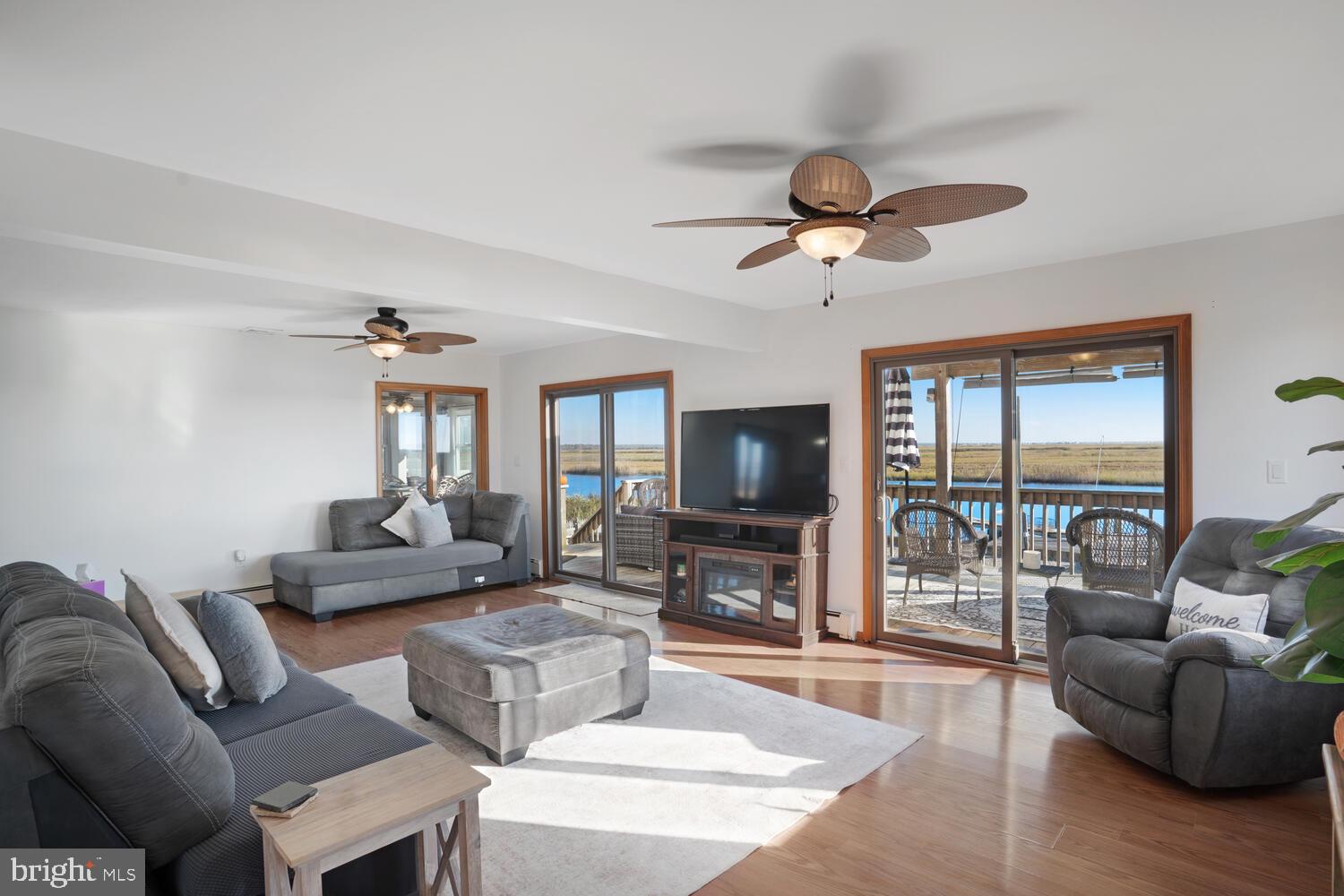 322 Dock Road West Creek, NJ 08092 - Photo 23 of 49 a living room with furniture a flat screen tv and a large window