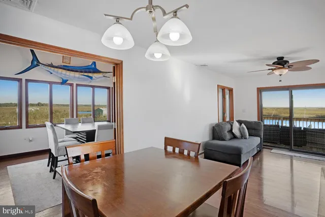 a view of a dining room with furniture window and wooden floor