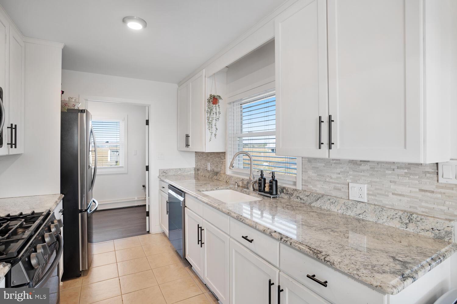 322 Dock Road West Creek, NJ 08092 - Photo 31 of 49 a kitchen with granite countertop a sink stove and cabinets
