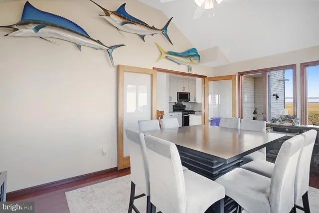 a dining room with furniture window and wooden floor