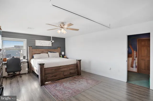 a bedroom with a large bed and dresser