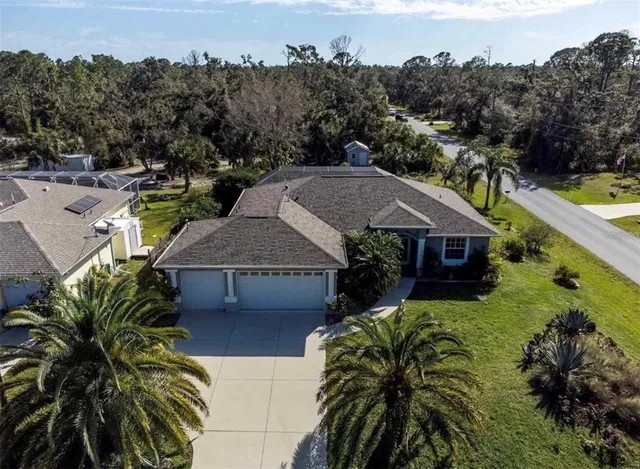 an aerial view of multiple houses with a yard