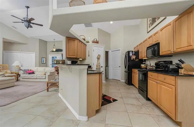 a kitchen with stainless steel appliances granite countertop a stove top oven a sink dishwasher and a refrigerator