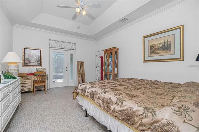 a spacious bedroom with a bed and a chandelier