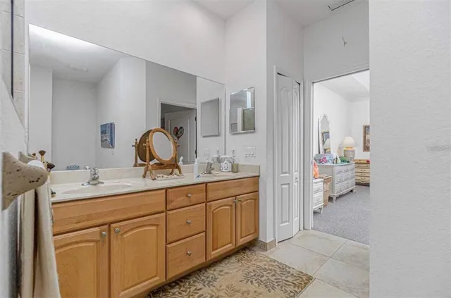 a en suite bathroom with double sink and a mirror