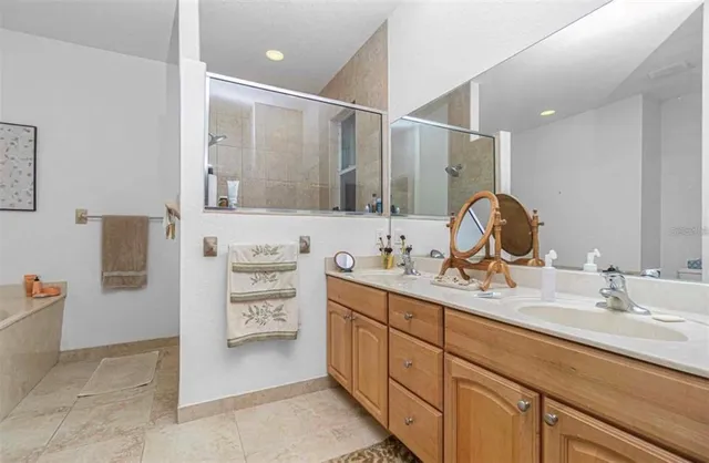 a bathroom with a double vanity sink a mirror and a