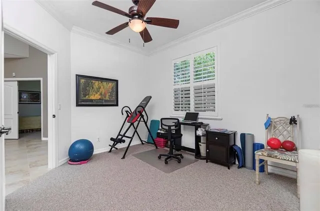 a view of a workspace with furniture and a window