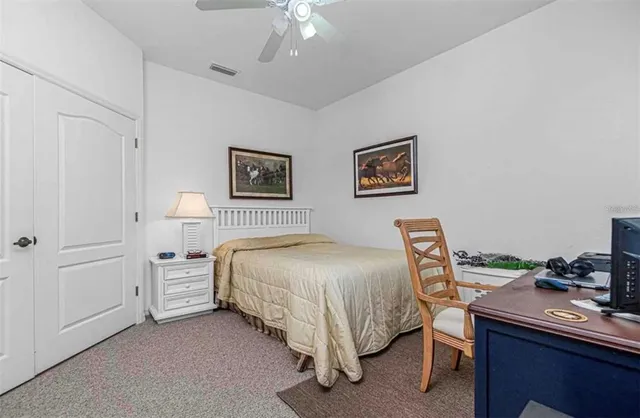 a bedroom with a bed and a desk