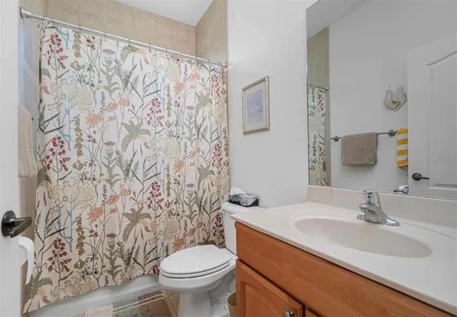 a bathroom with a sink toilet and a mirror