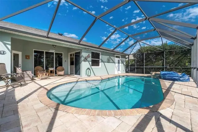 a view of a swimming pool with sitting area