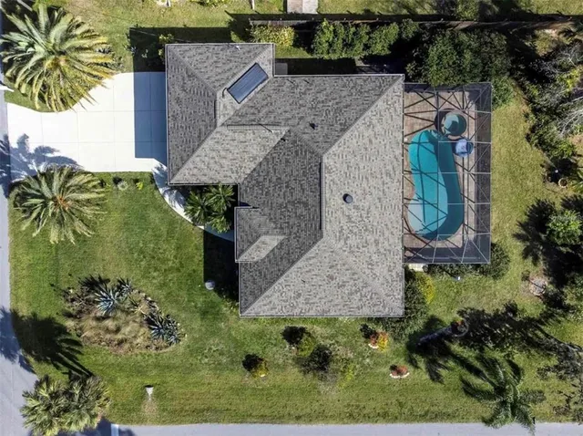 an aerial view of a house with outdoor space