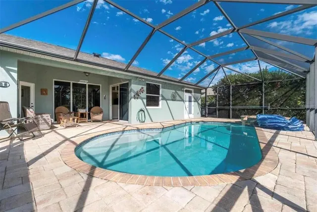 a view of a swimming pool with sitting area
