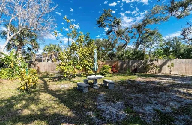 a backyard of a house with a yard and outdoor seating