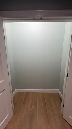 a view of a room with wooden floor