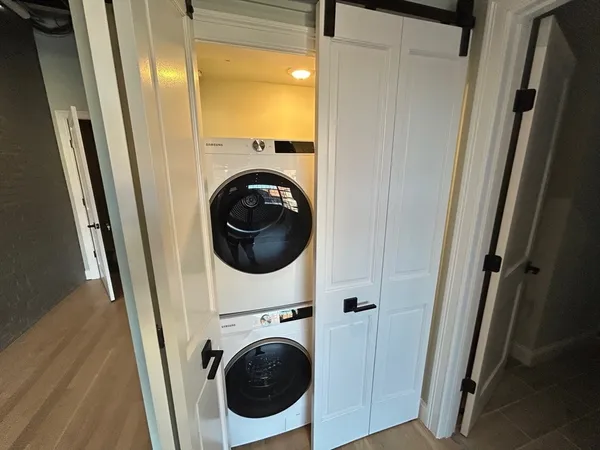 a view of a hallway with washer and dryer