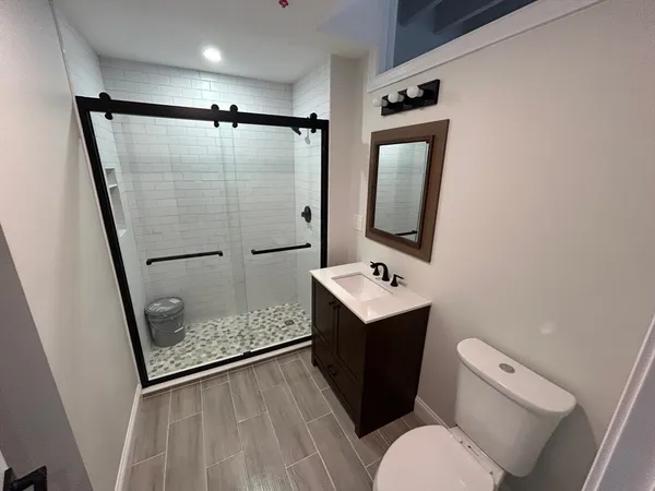 a bathroom with a toilet sink and shower