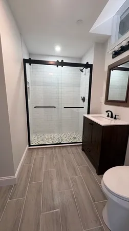 a bathroom with a sink a toilet a mirror and vanity