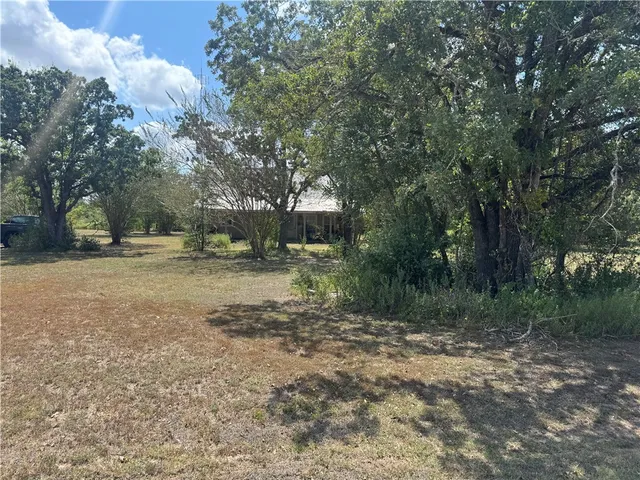a backyard of a house with lots of green space