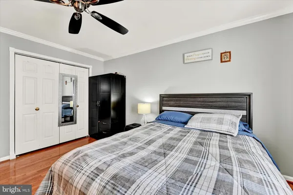 a bedroom with a bed and mirror