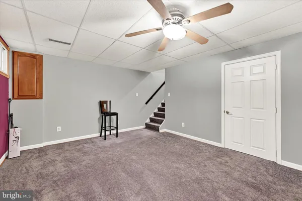 a view of an empty room with a fan