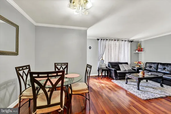 a living room with furniture a fireplace and a chandelier