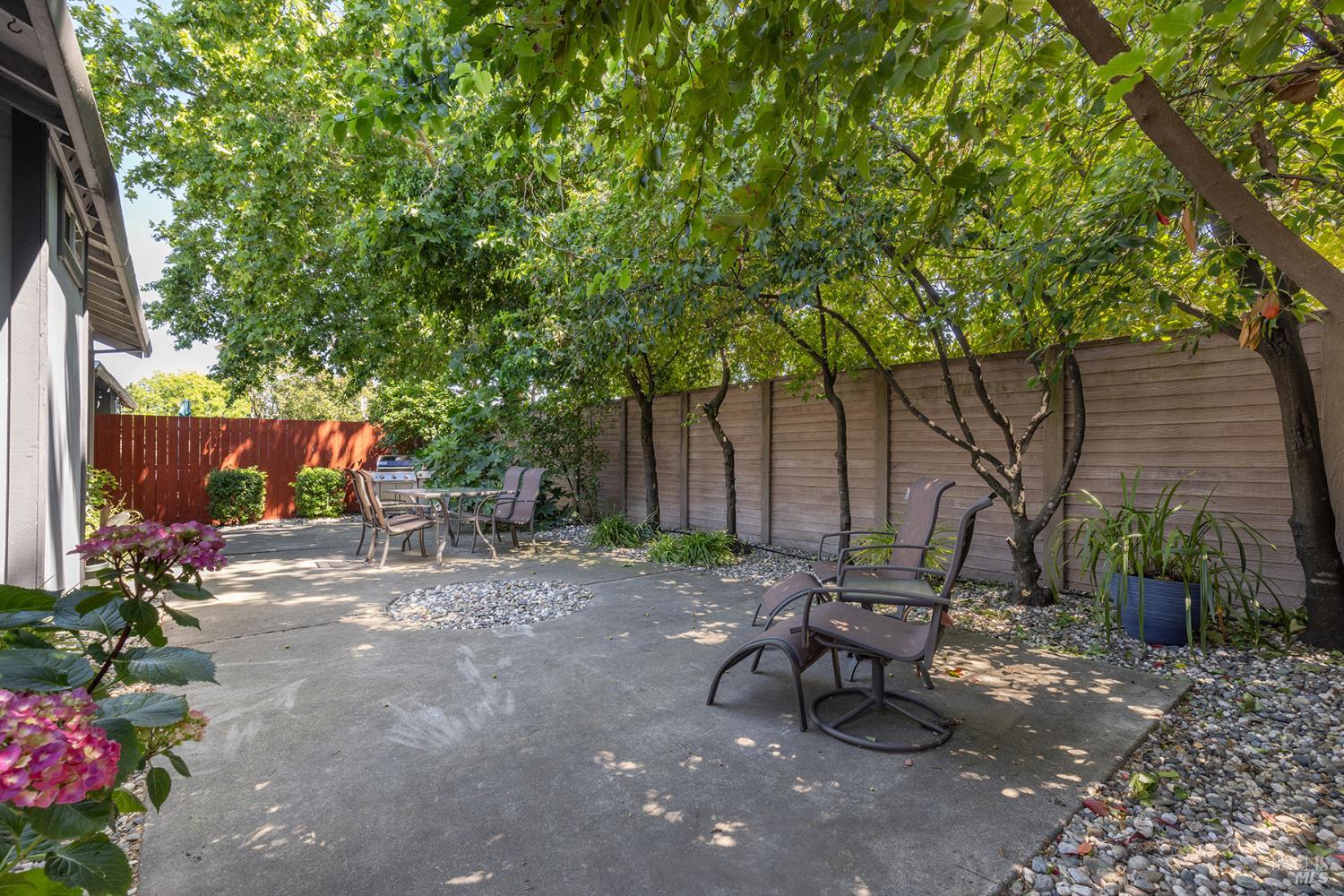 1935 Seville Street Santa Rosa, CA 95403 - Photo 19 of 30 a view of a backyard with table and chairs and a large tree