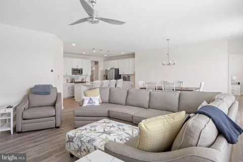 a living room with furniture and kitchen view