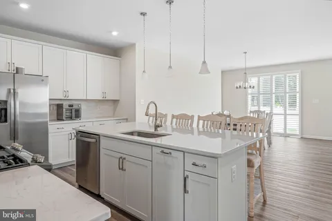 a kitchen with a sink stove and refrigerator