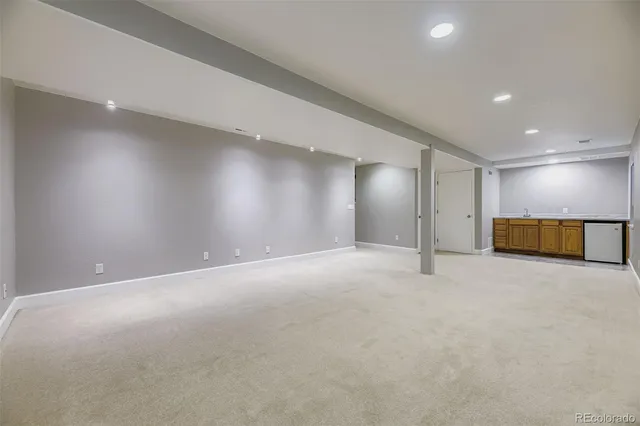 an empty room with a empty space and windows