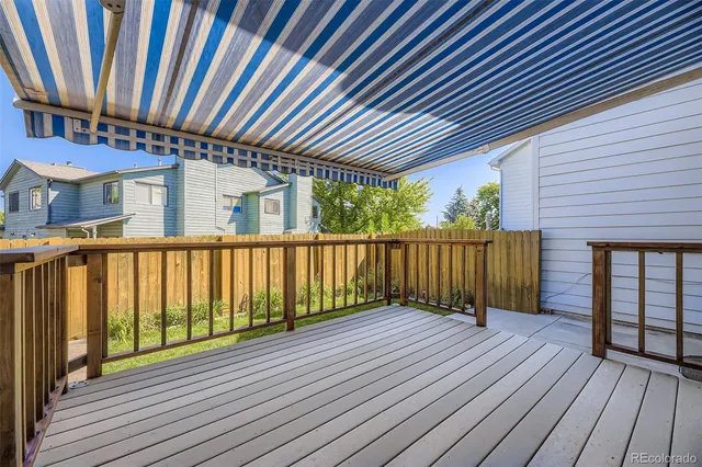 a view of a backyard with potted plants and large tree