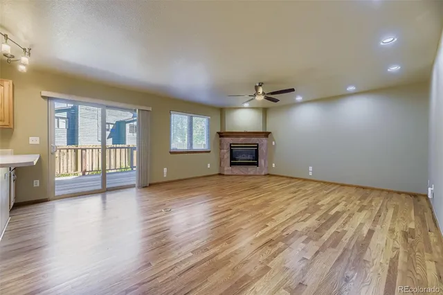 wooden floor in an empty room with a fireplace and wooden floor