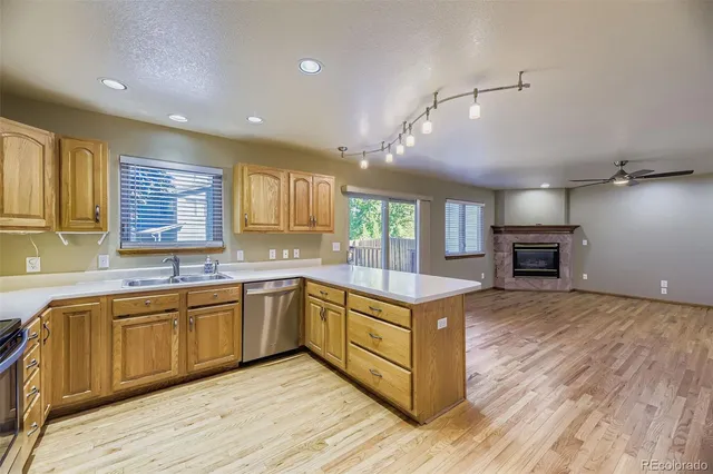 a kitchen with wooden floors and wooden cabinets