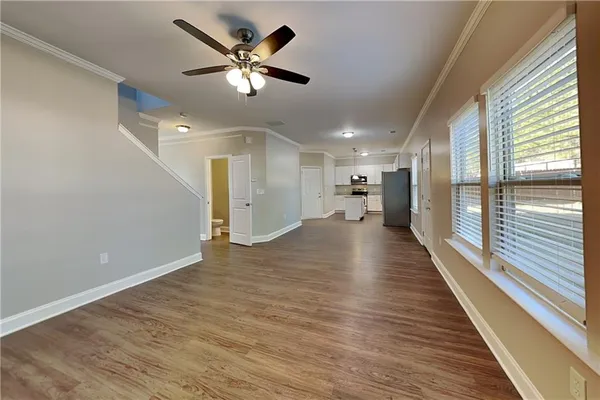 a view of a hallway with wooden floor