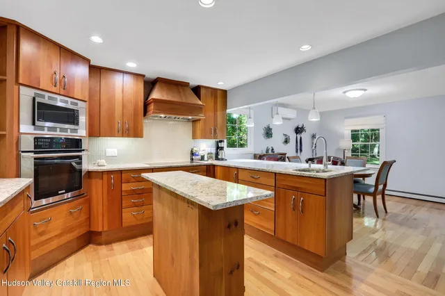 a kitchen with stainless steel appliances granite countertop sink stove top oven and microwave