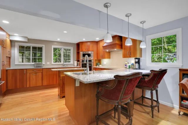 a kitchen with a table chairs sink and cabinets