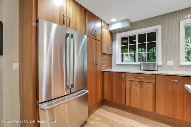 a kitchen with stainless steel appliances granite countertop a refrigerator and a sink