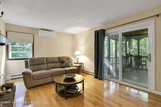 a living room with furniture and a floor to ceiling window