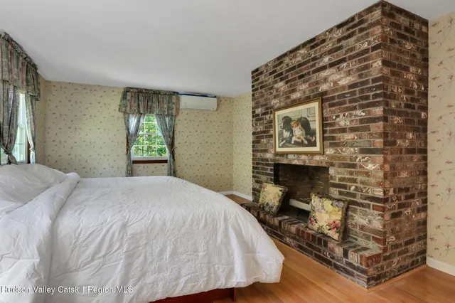 a bed sitting in a bedroom next to a window