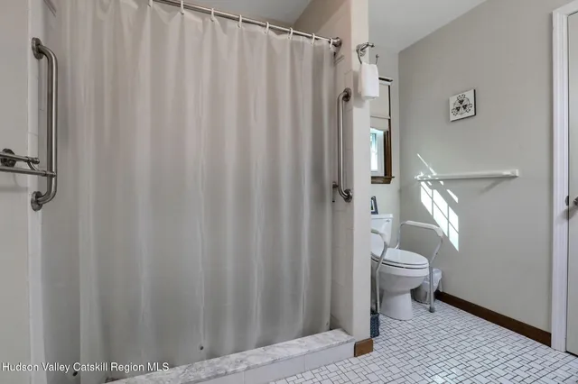 a bathroom with a toilet a sink and a shower