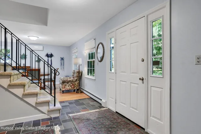 a view of entryway dining room and hall with wooden floor