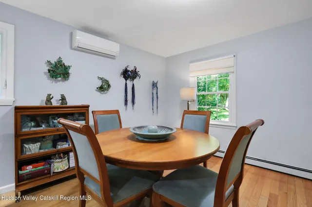 a view of a dining room with furniture and a potted plant