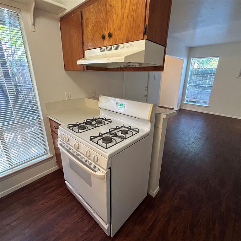 1011 West 23rd Street, Unit 102 Austin, TX 78705 - Photo 4 of 10 a white stove top oven sitting inside of a kitchen