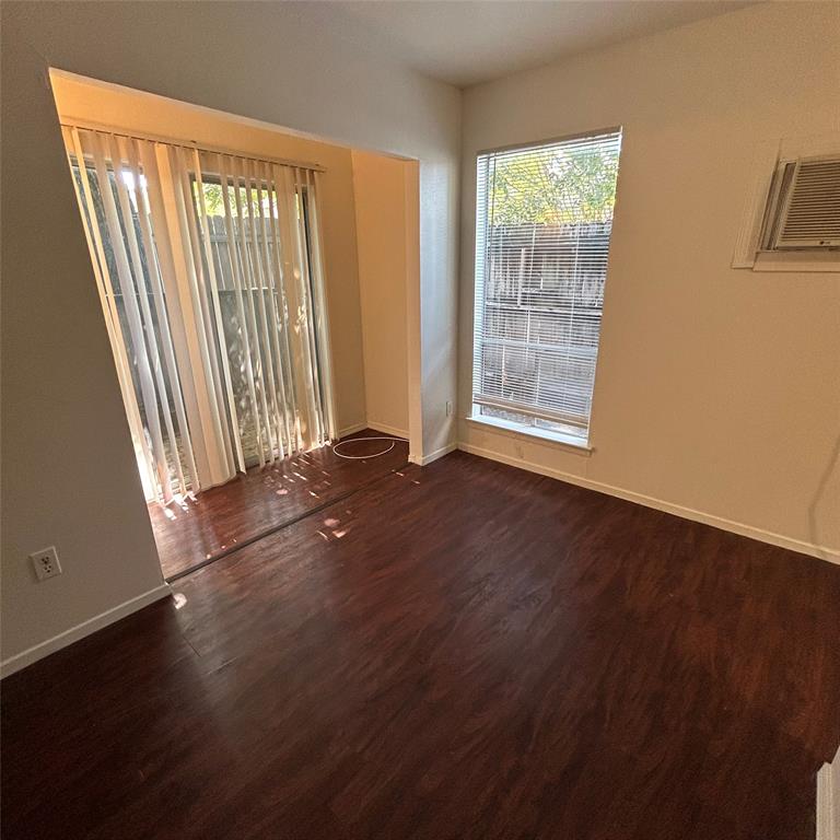 1011 West 23rd Street, Unit 102 Austin, TX 78705 - Photo 5 of 10 an empty room with wooden floor and windows