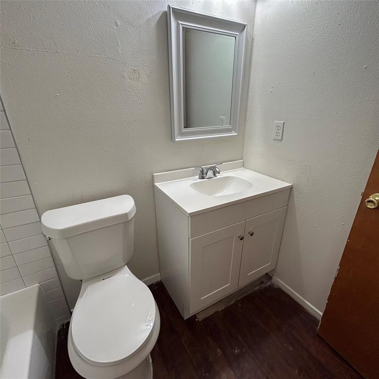 1011 West 23rd Street, Unit 102 Austin, TX 78705 - Photo 7 of 10 a white toilet sitting next to a bathroom sink