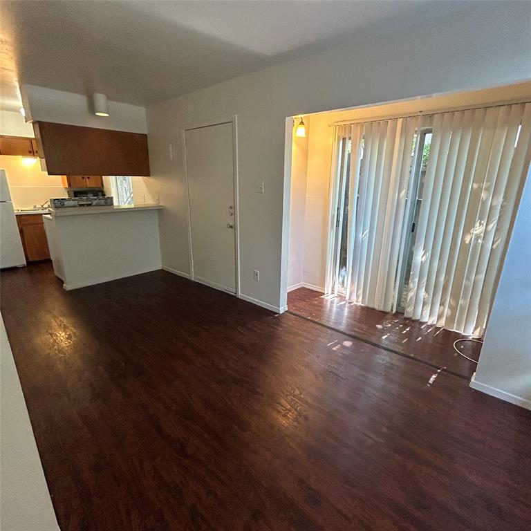 1011 West 23rd Street, Unit 102 Austin, TX 78705 - Photo 9 of 10 an empty room with wooden floor and windows