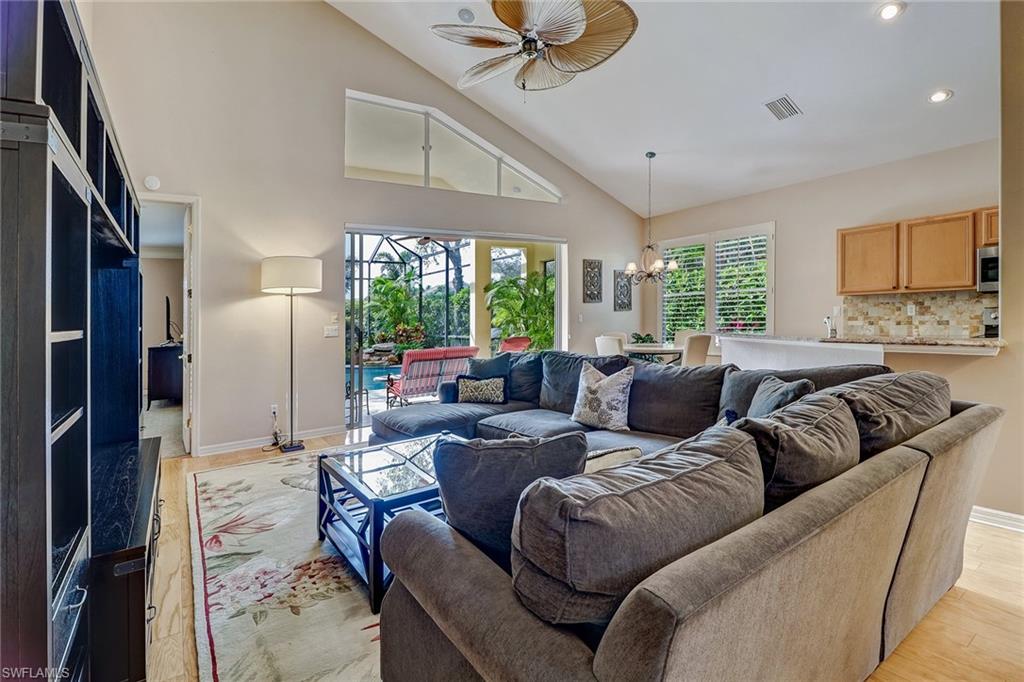 1908 Timarron Way Naples, FL 34109 - Photo 9 of 20 a living room with furniture and a large window