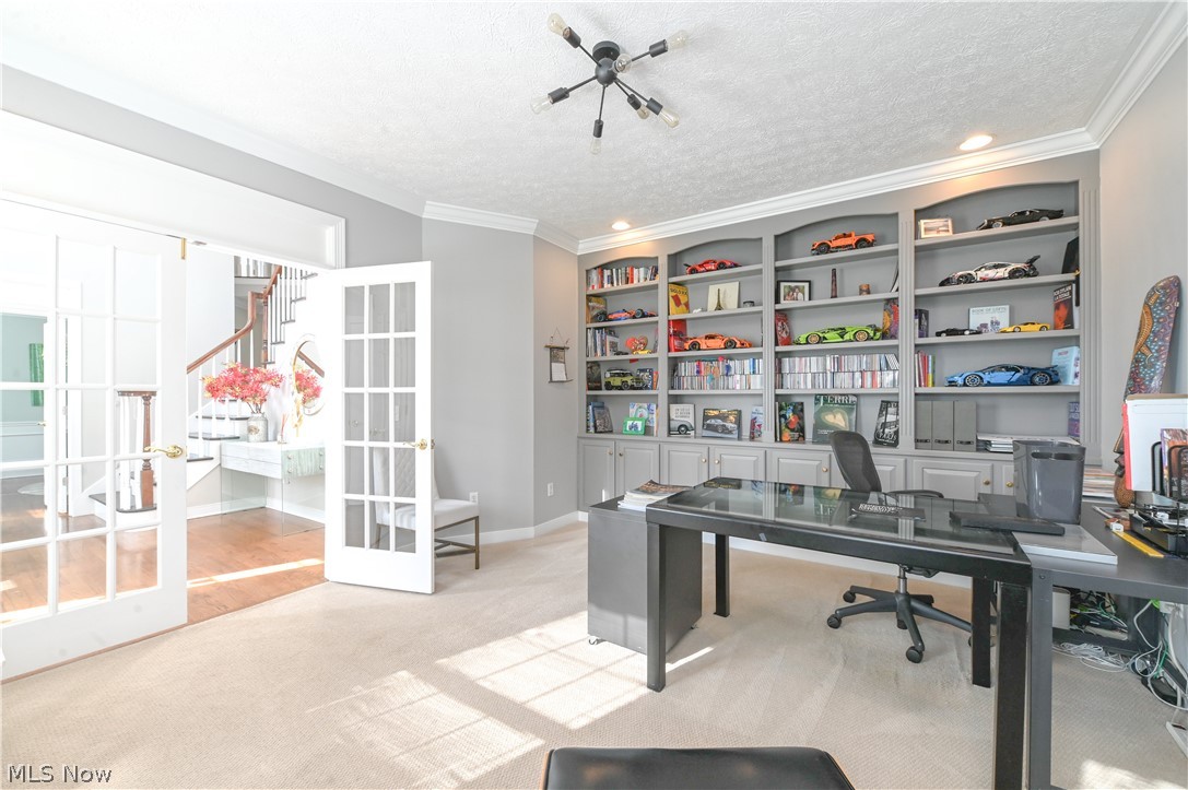 1688 Sheridan Road South Euclid, OH 44121 - Photo 13 of 48 Carpeted home office featuring french doors, crown molding, built in features, and a textured ceiling
