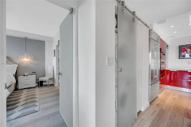 a walk in closet with view of bathroom