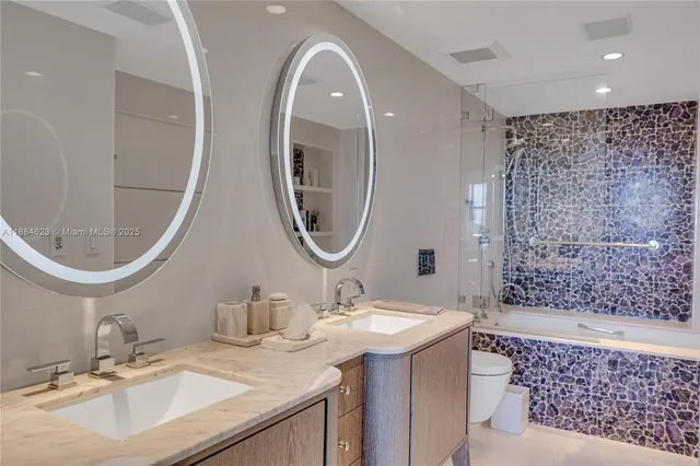 a bathroom with a bathtub a sink and a mirror